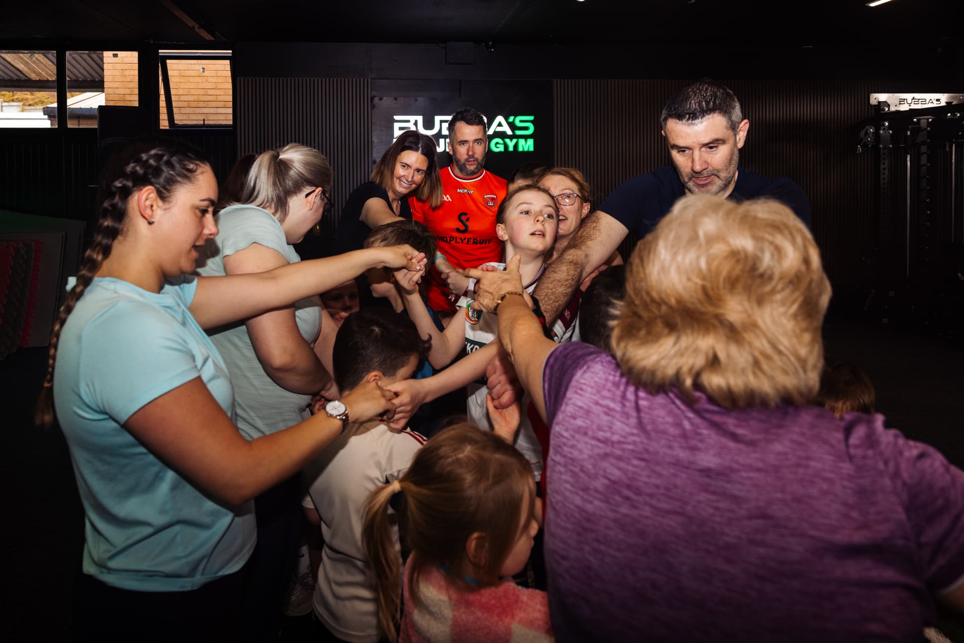 The Bubba's Project Gym community in a team huddle