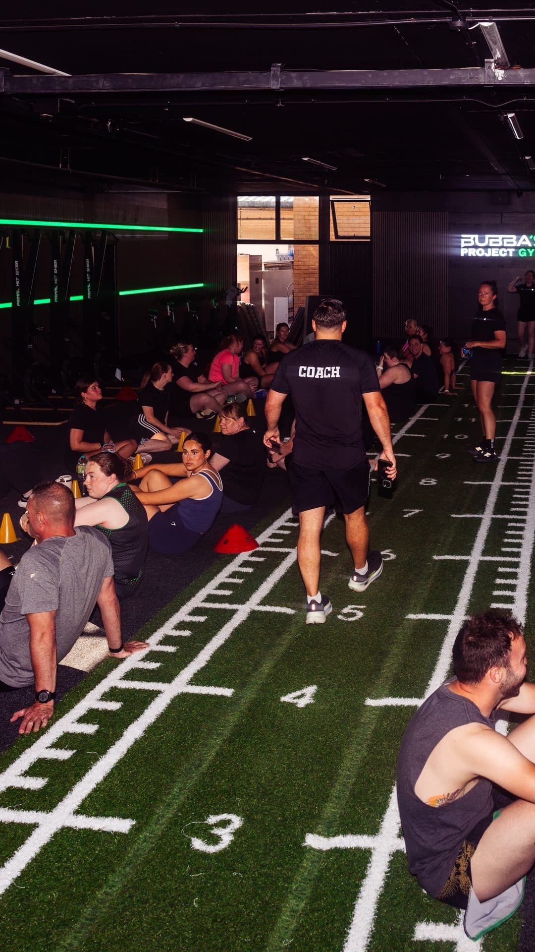 The Bubba's Project Gym community together under the gym sign